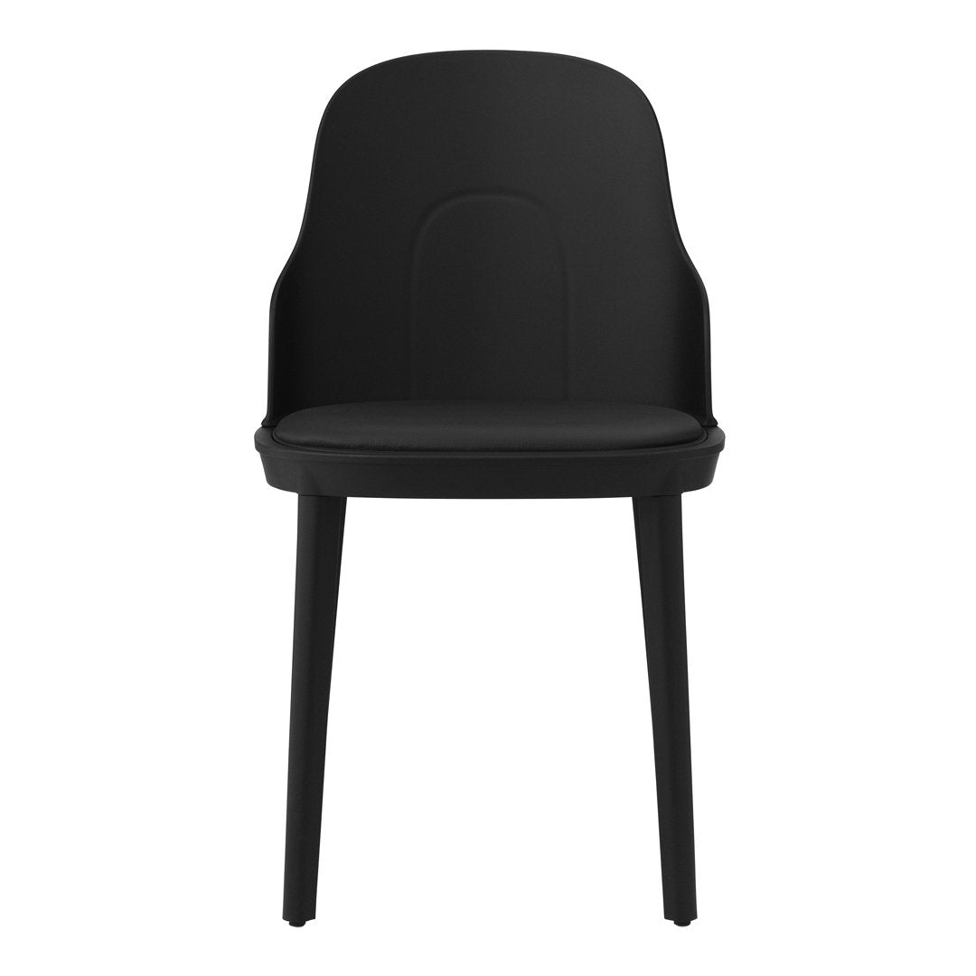 Black minimalist chair with a sleek, smooth finish and curved backrest, perfect for modern decor.