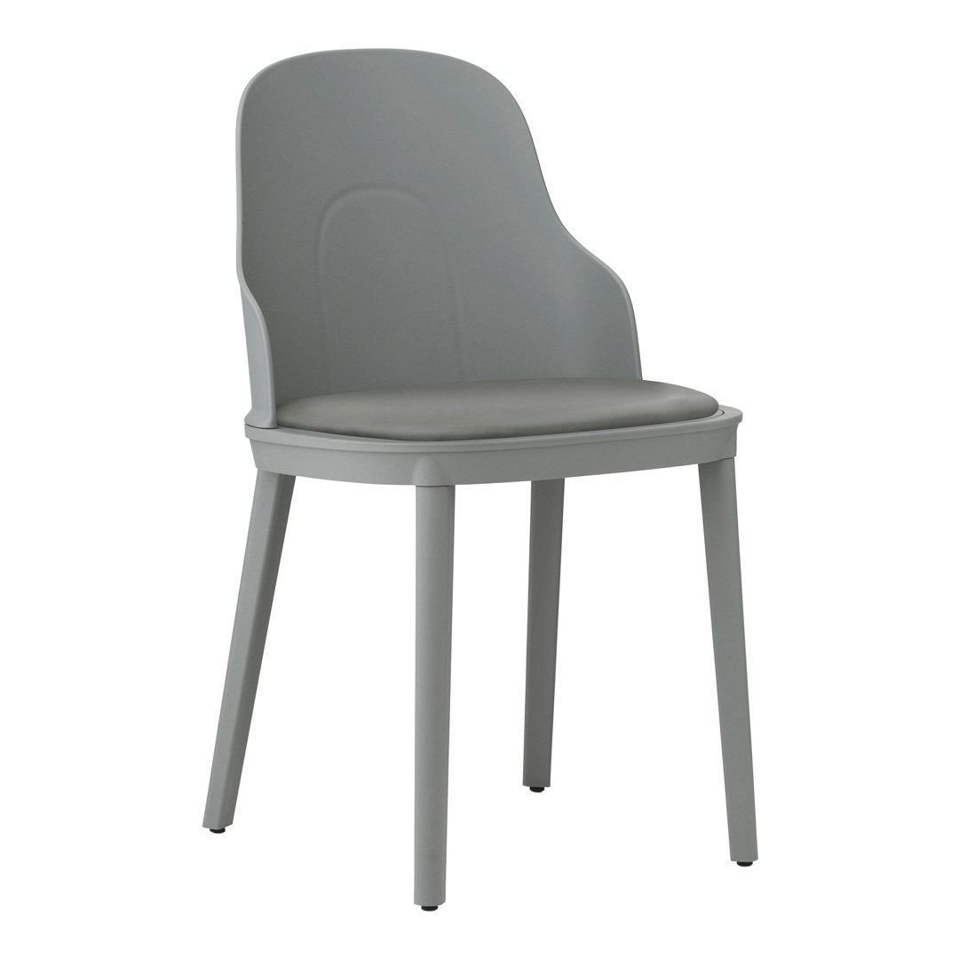 Gray plastic chair with a smooth finish and minimalist design, featuring a matching gray cushion.
