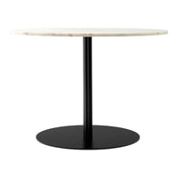 Round white marble tabletop on a sleek black metal base, featuring a minimalistic design and smooth surface.