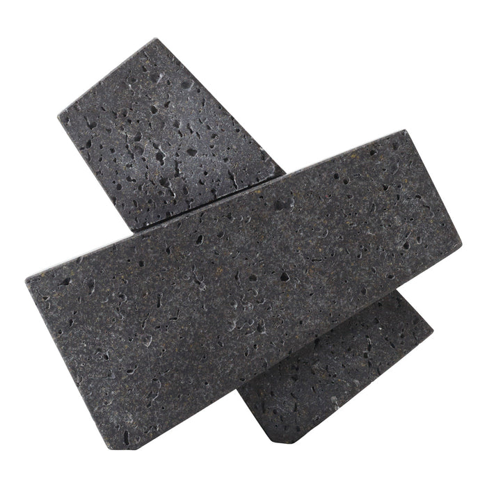 Black geometric decorative stones with a textured surface and varying angles. Elegant modern minimalist design.