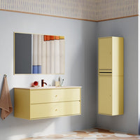 Yellow bathroom furniture with modern lines, featuring a two-tone striped curtain and patterned floor tiles.