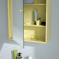 "Yellow wall-mounted cabinet with a glass door, showcasing minimalistic design and clean lines against a soft blue background."