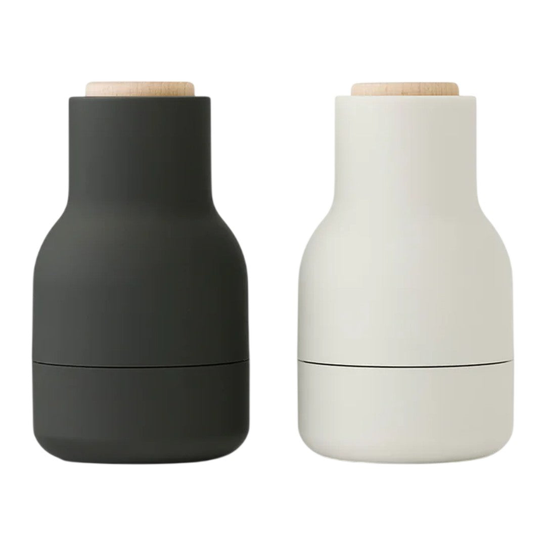Stylish black and white ceramic containers with wooden lids, featuring sleek, modern designs for home decor.