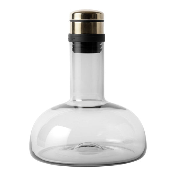 Clear glass decanter with a gold and black metallic stopper, featuring a smooth, modern design.