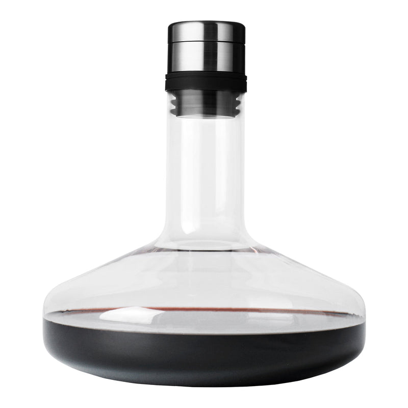 Clear glass decanter with a smooth black base and stainless steel cap, showcasing rich dark red liquid inside.