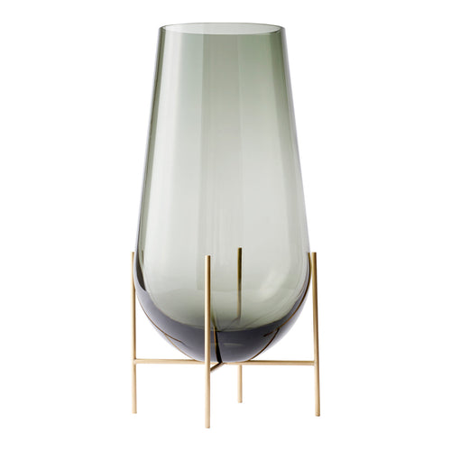 Green-tinted glass vase with a smooth gradient and chic gold metal stand, perfect for modern decor.
