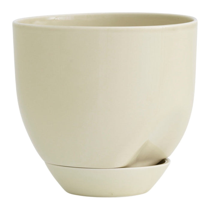 Beige ceramic planter with smooth matte finish and matching saucer. Minimalist design adds elegance to any space.