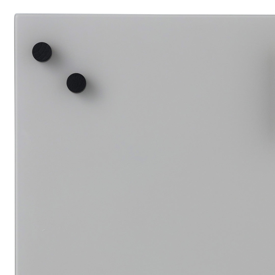 Gray surface with two black round knobs, minimalist design and smooth texture. Perfect for modern spaces.
