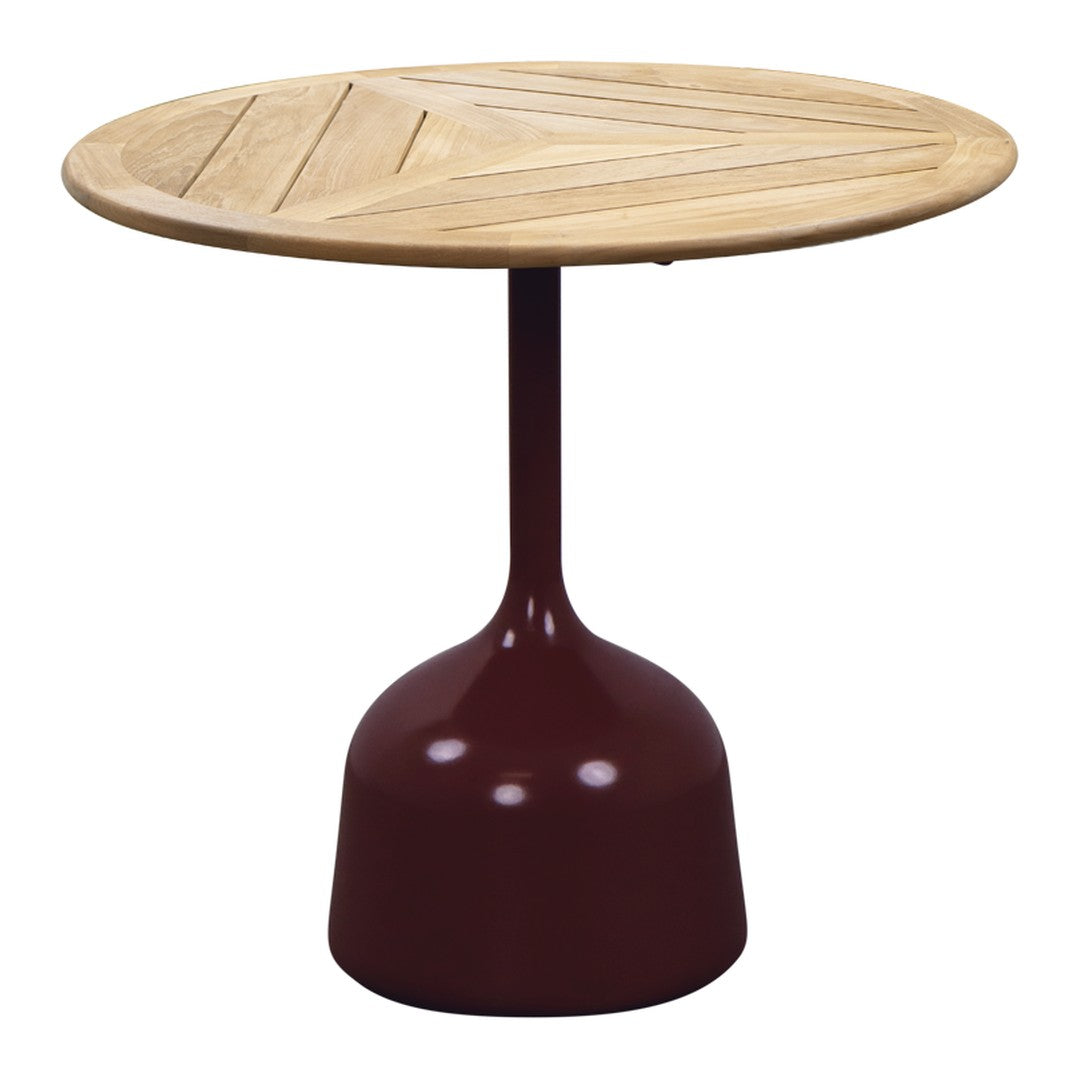 Round wooden table with a natural finish and deep burgundy base, featuring a chevron pattern on the tabletop.