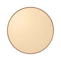Round mirror with a smooth, beige surface and a thin, warm-toned brown frame.