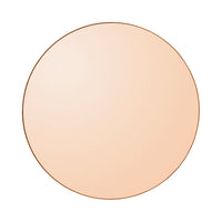 Round blush mirror in soft peach tone with a sleek gold outline. Ideal for elegant home decor.
