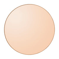 Round mirror with a soft peach gradient and a sleek copper edge, perfect for modern decor.