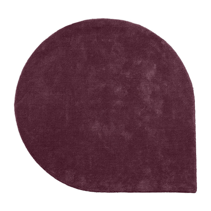Plush round rug in deep burgundy color with a soft, textured finish. Ideal for adding elegance to any room.