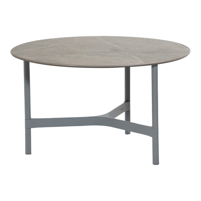 Round table with a light gray finish and subtle wood grain pattern, featuring a sleek gray metal base.