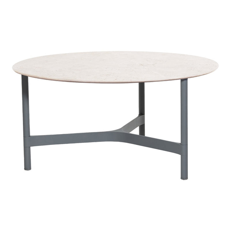 Round coffee table with a light beige top and dark gray metal legs, featuring a sleek, modern design.
