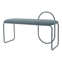 Modern upholstered bench in soft grey fabric with sleek, curved metal legs and circular accent detail.