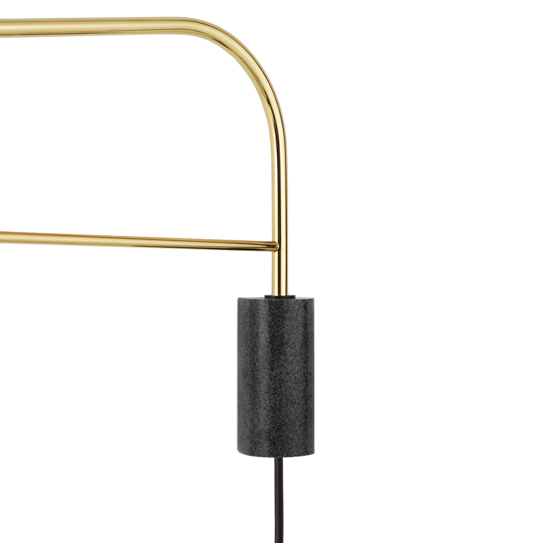 Gold metal frame with a sleek black cylindrical base, creating a modern and stylish contrast.