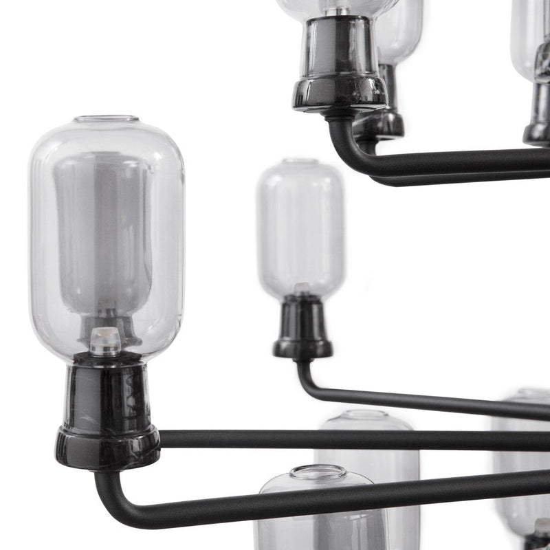 Glass bulb chandelier with black metal arms, showcasing a sleek, modern design and clear glass accents.