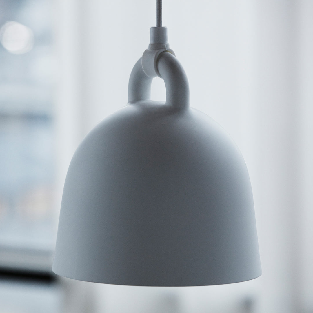 White dome pendant lamp with a smooth matte finish and minimalist design, featuring a subtle hanging loop detail.