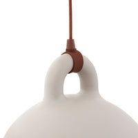 White ceramic lamp with a smooth finish and a brown leather accent at the hanging point.