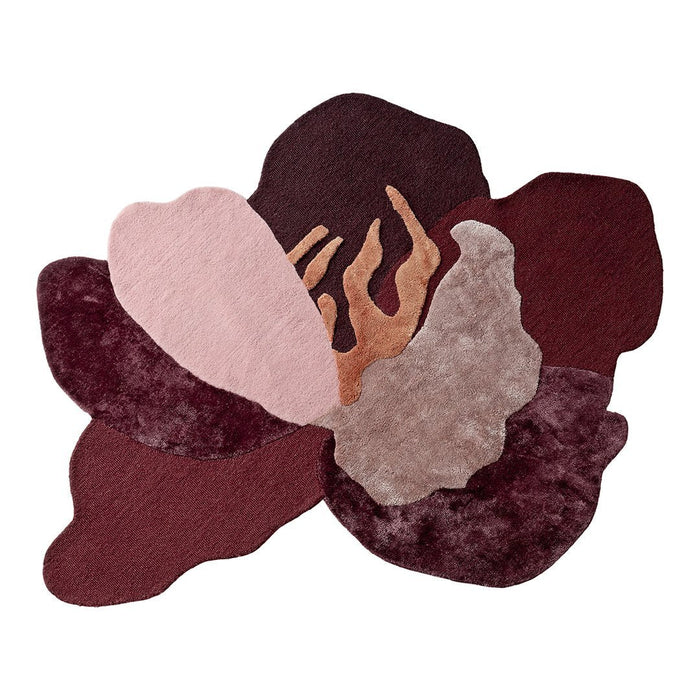 Multicolored rug featuring deep burgundy, soft pink, and neutral tones in an abstract floral pattern.