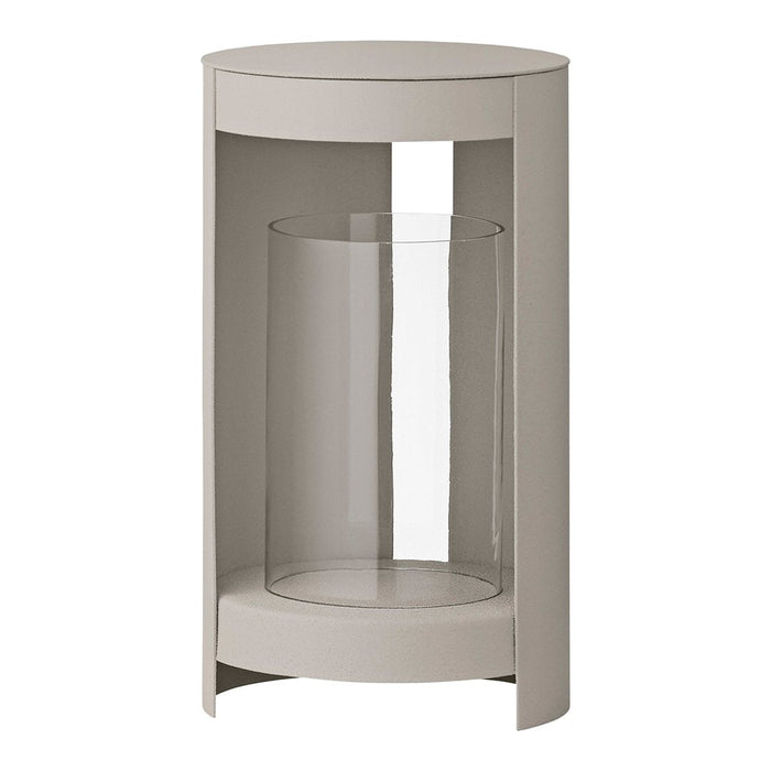 Round beige table with a clear glass insert, featuring a sleek, minimalist design and a smooth surface.