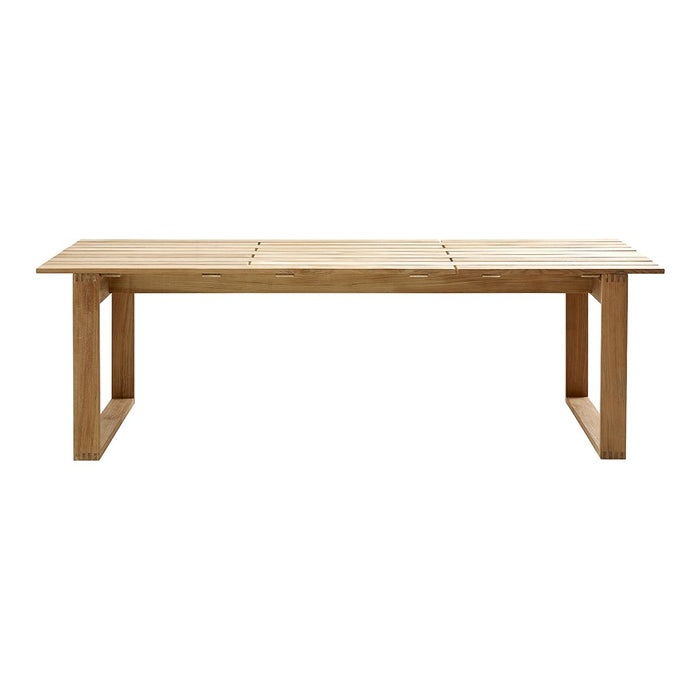 Natural wood dining table in a warm, light brown finish, featuring a simple and sleek design with horizontal lines.