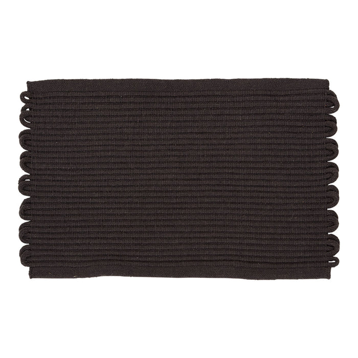 Black rectangular mat with textured ridges and decorative scalloped edges. Perfect for modern decor.