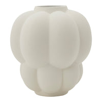 White textured ceramic vase with a unique pumpkin-inspired shape and soft, matte finish. Elegant minimalist design.