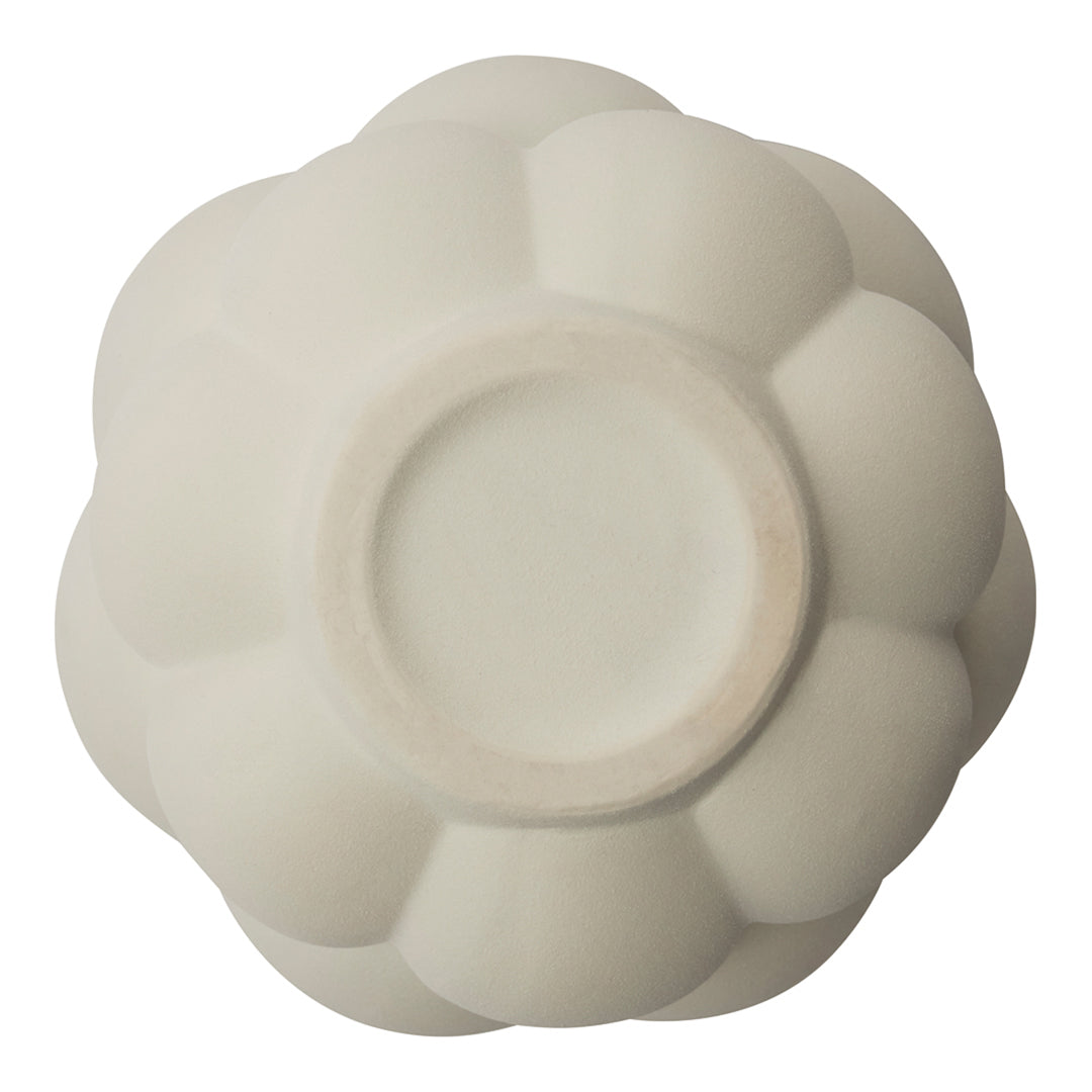 White ceramic bowl with a soft, glossy finish and a floral petal design. Perfect for elegant table settings.