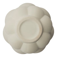 White ceramic bowl with a soft, glossy finish and a floral petal design. Perfect for elegant table settings.