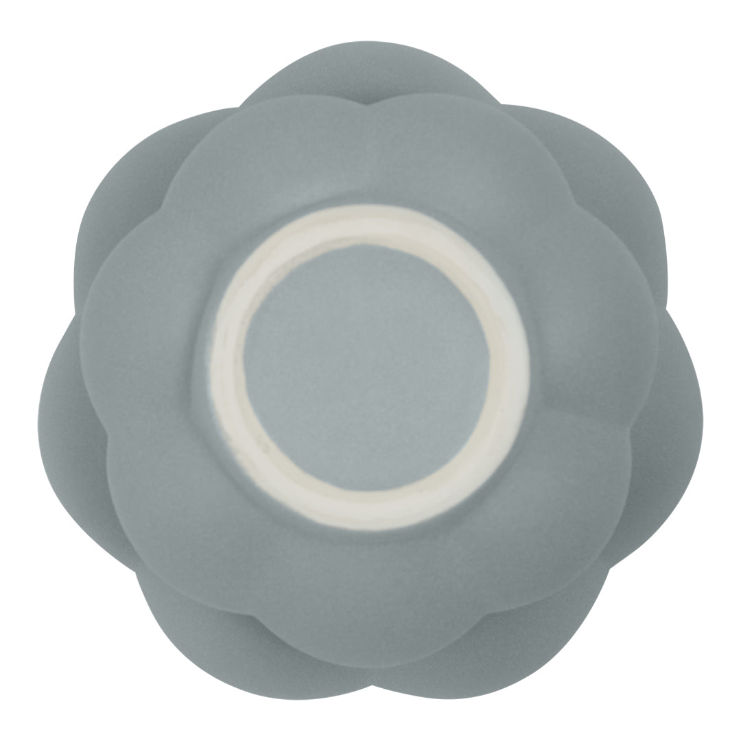 Gray flower-shaped dish with a smooth surface and white center, perfect for modern table settings.