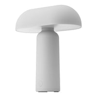 White mushroom-shaped table lamp with a smooth matte finish and sleek cylindrical base.