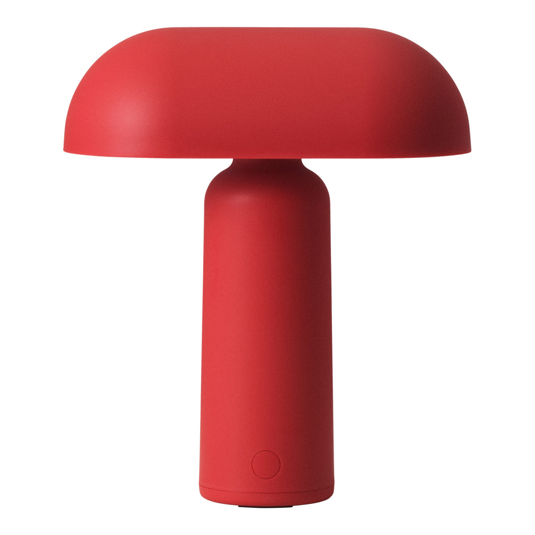 Red lamp with a smooth, rounded shade and a cylindrical base, showcasing a modern, minimalist design.