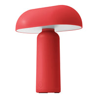 Red mushroom-shaped table lamp with a smooth, matte finish and a white shade. Perfect for modern decor.