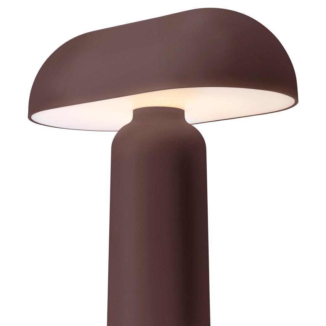 Brown modern lamp with a smooth, rounded shade and a sleek cylindrical base, highlighting minimalistic design.