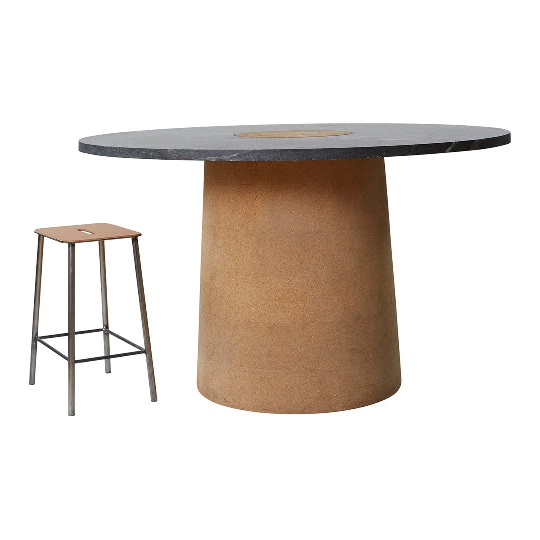 Round black tabletop with a warm beige base, complemented by a wooden stool in natural tones. Modern, minimalist design.