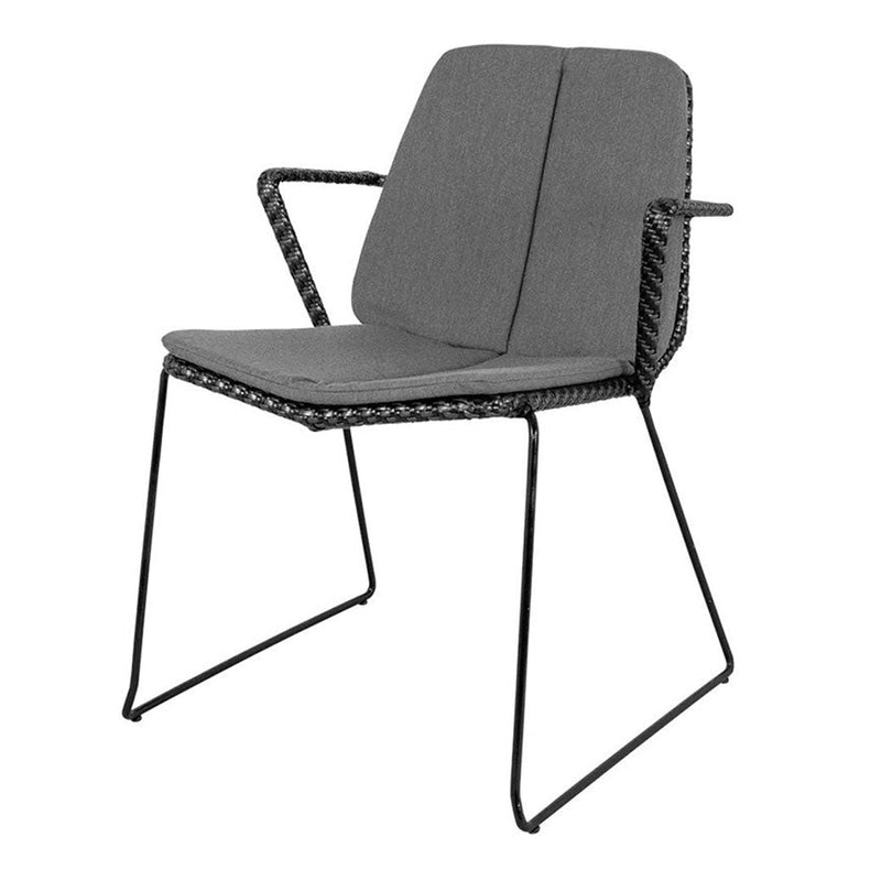 Gray upholstered chair with a sleek black metal frame and woven detail on the edges. Modern and minimalist design.