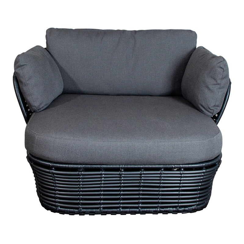 Stylish gray upholstered chair with black woven base and matching arm cushions, perfect for modern decor.