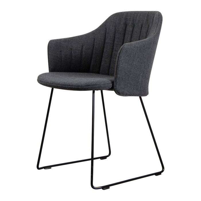 Gray upholstered chair with vertical stitching and sleek black metal frame, perfect for modern decor.