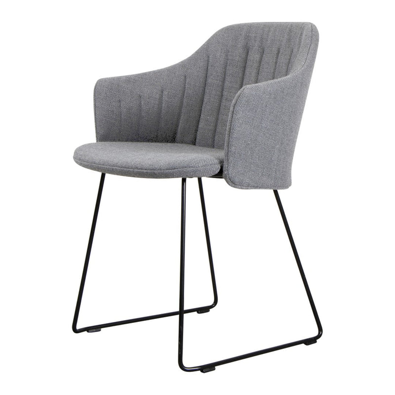 Gray upholstered chair with vertical ribbed pattern and sleek black metal legs. Modern and stylish for any space.