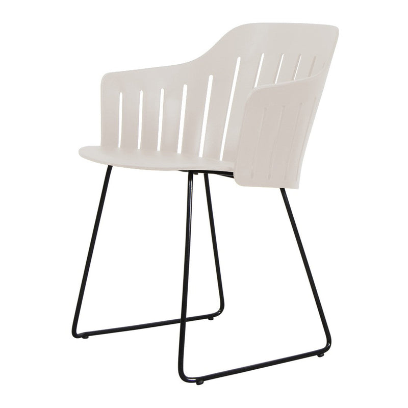 Light cream armchair with slatted design and sleek black metal legs, perfect for modern decor.