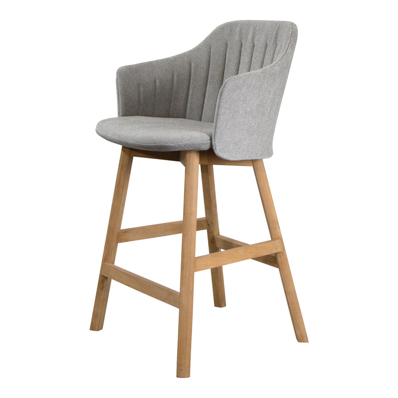 Gray upholstered bar stool with ribbed pattern and natural wood legs, perfect for modern interiors.