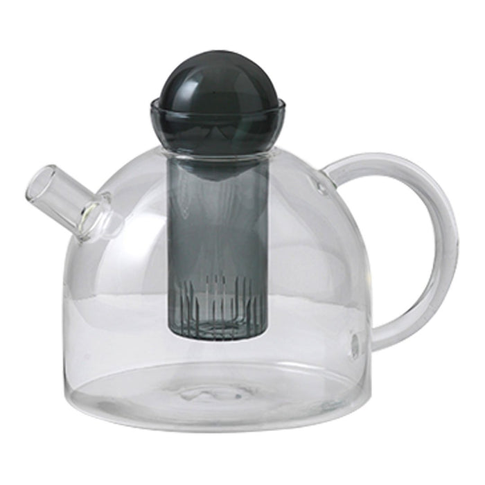 Clear glass teapot with a sleek black infuser and rounded dome shape, featuring minimalist design.