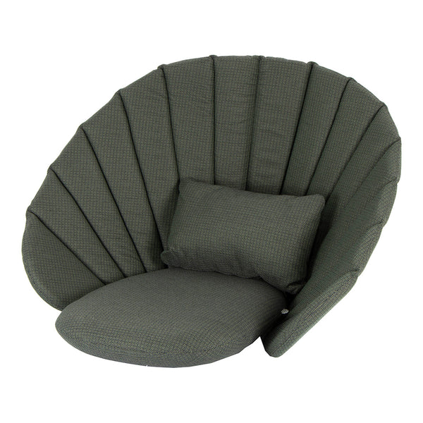 Green shell-shaped chair with padded, vertical stripes and a matching cushion. Modern, cozy design for any space.