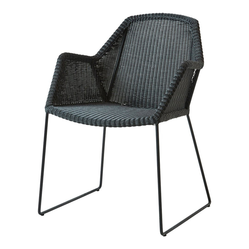 Black woven armchair with a modern geometric pattern and sleek metal legs. Perfect for contemporary decor.