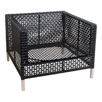 Black wicker armchair with geometric cut-out patterns and silver metal legs.