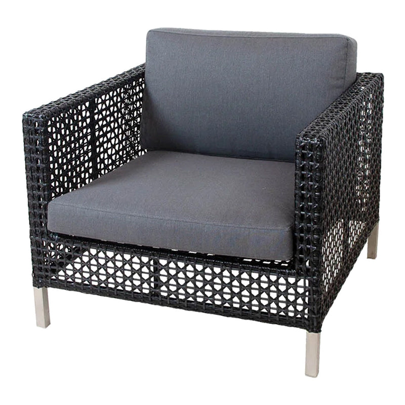 Gray cushioned chair with a black woven rattan frame and silver metal legs, showcasing a modern and textured design.