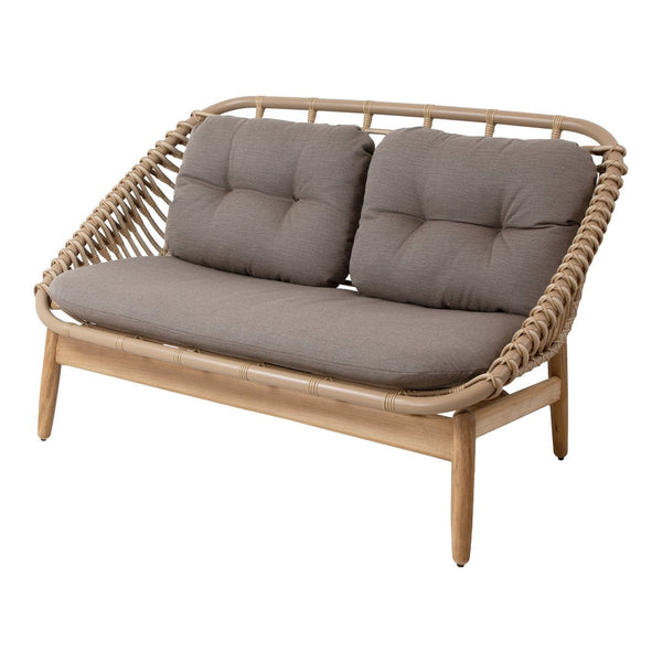 Natural rattan sofa with soft gray cushions and a sleek, contemporary pattern. Perfect for stylish living spaces.