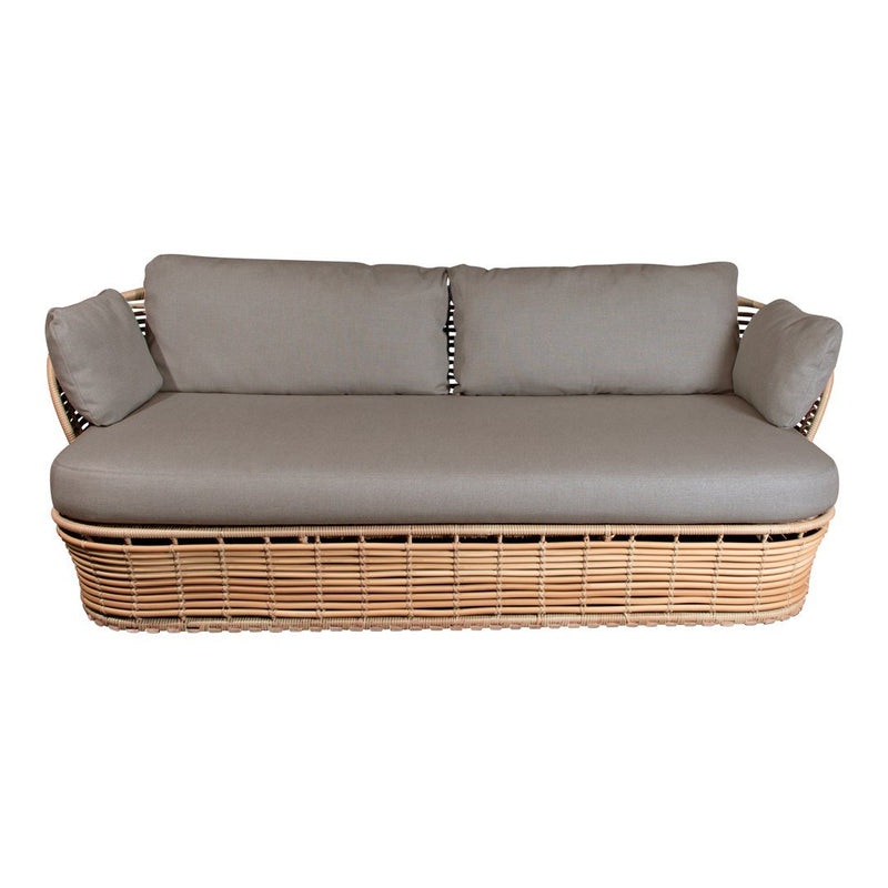 Light gray cushions on a natural wicker sofa with a sleek, textured design. Perfect for modern or bohemian decor.